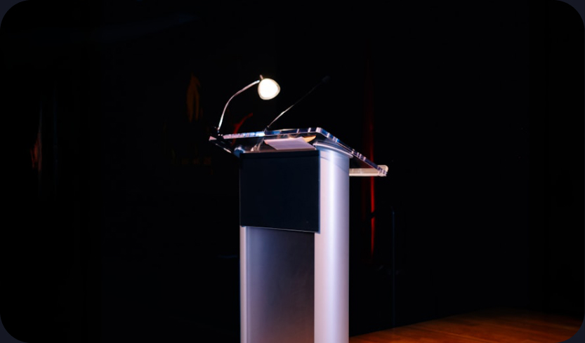 A speaker at a podium during the beta announcement